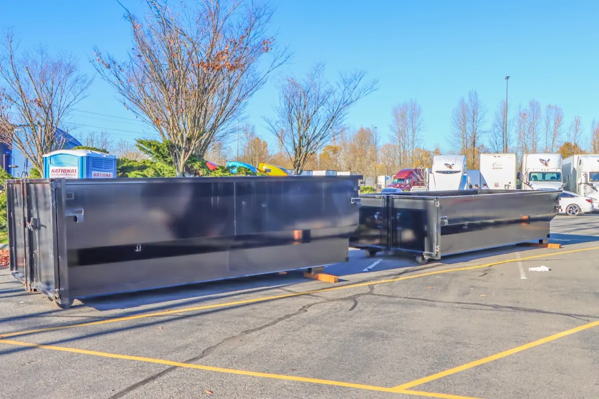 Professional dumpster rental service with roll-off container on residential driveway in Baltimore